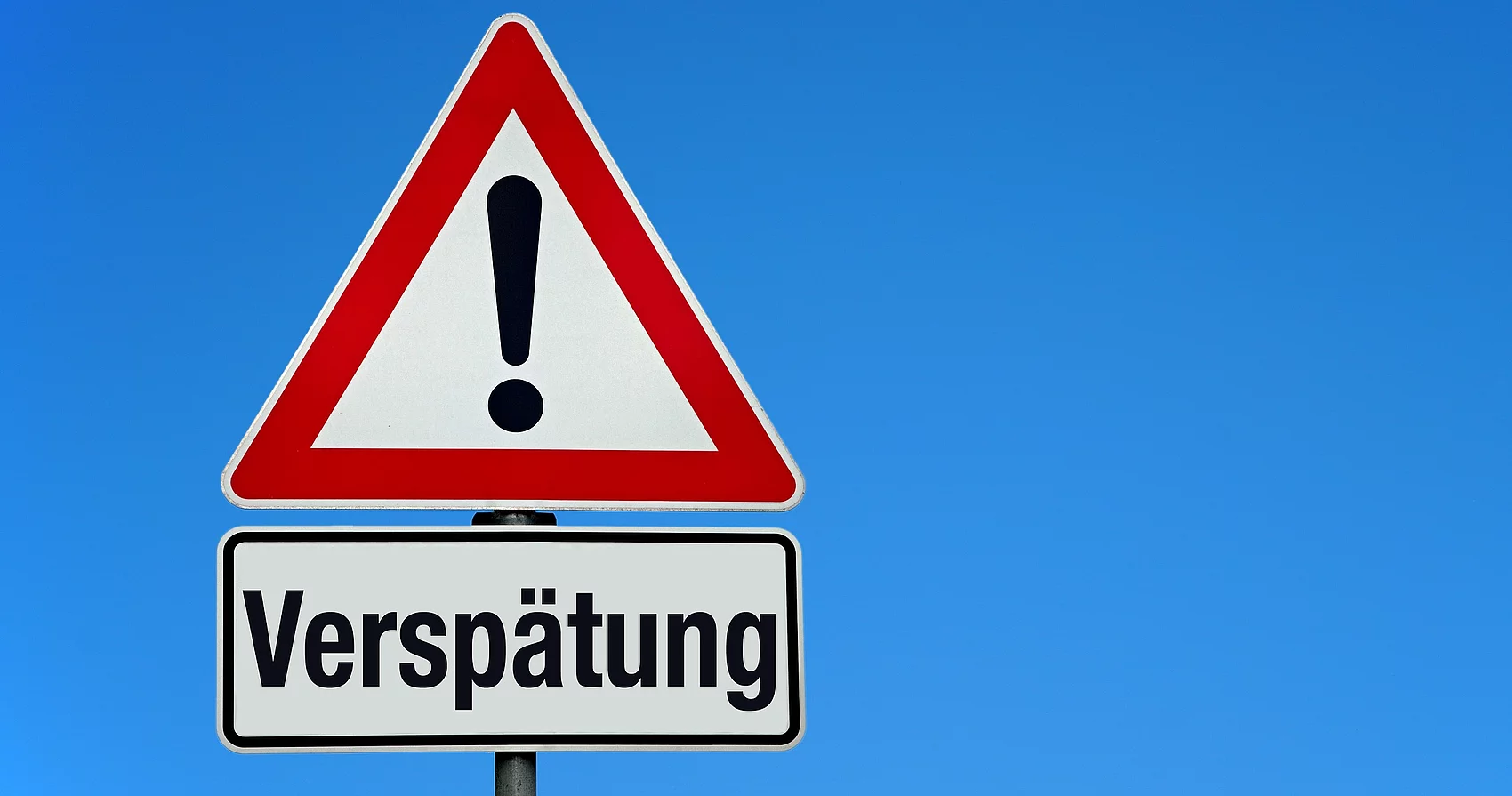 Symbolbild Verkehrsschild Achtung Verspätung